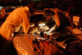 Two people are fixing the car