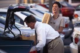 They are loading their groceries into the trunk