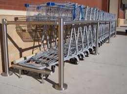 Many shopping carts are lined up in a row.